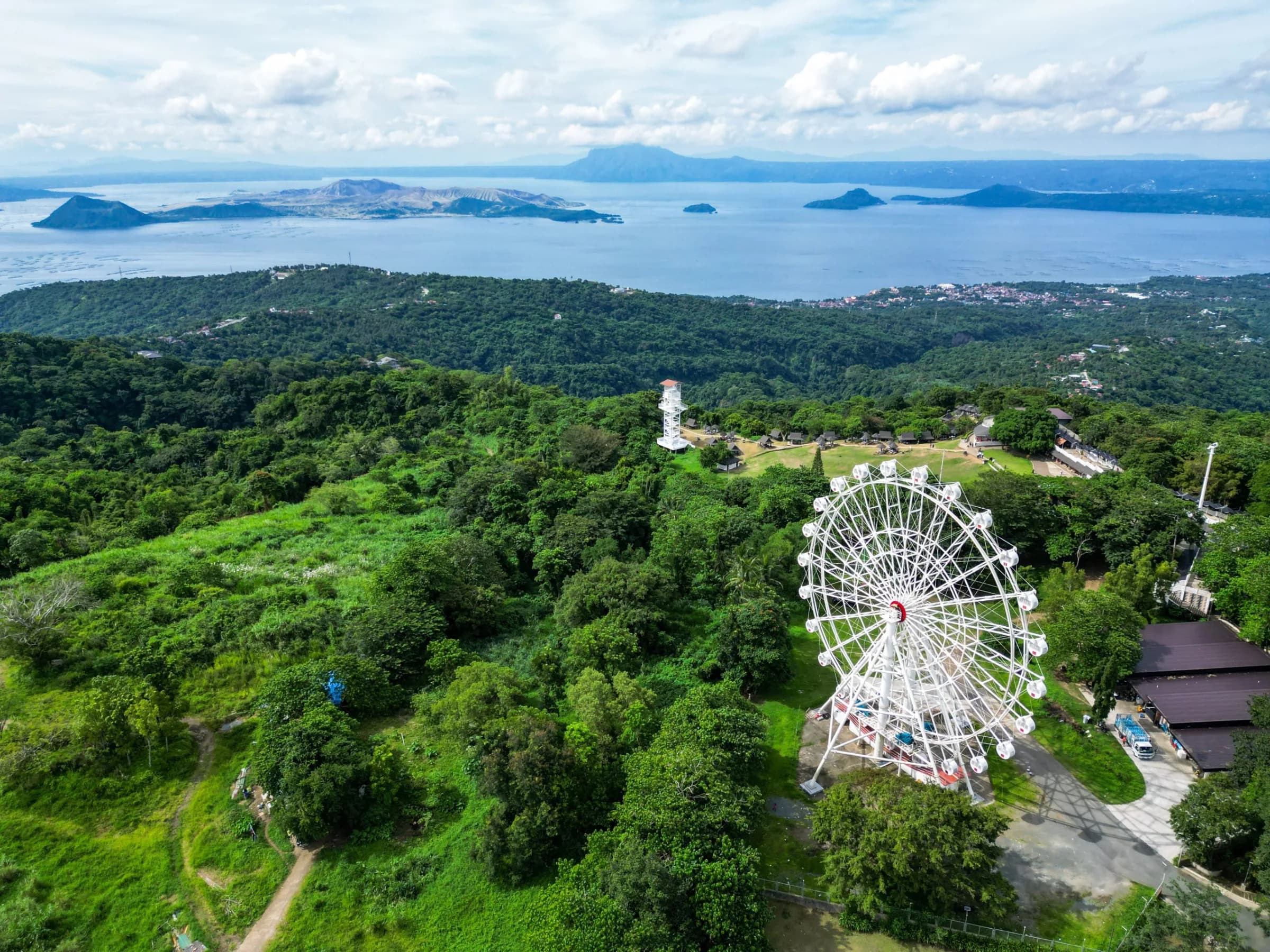 Panoramic view of Taal Lake and Taal Volcano surrounded by lush scenery in Tagaytay, Philippines.