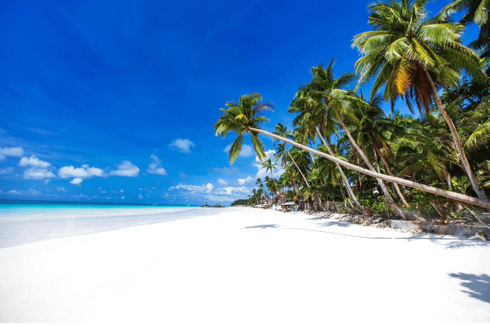 Powdery white sand, turquoise waters and tropical scenery along White Beach in Boracay, Philippines.