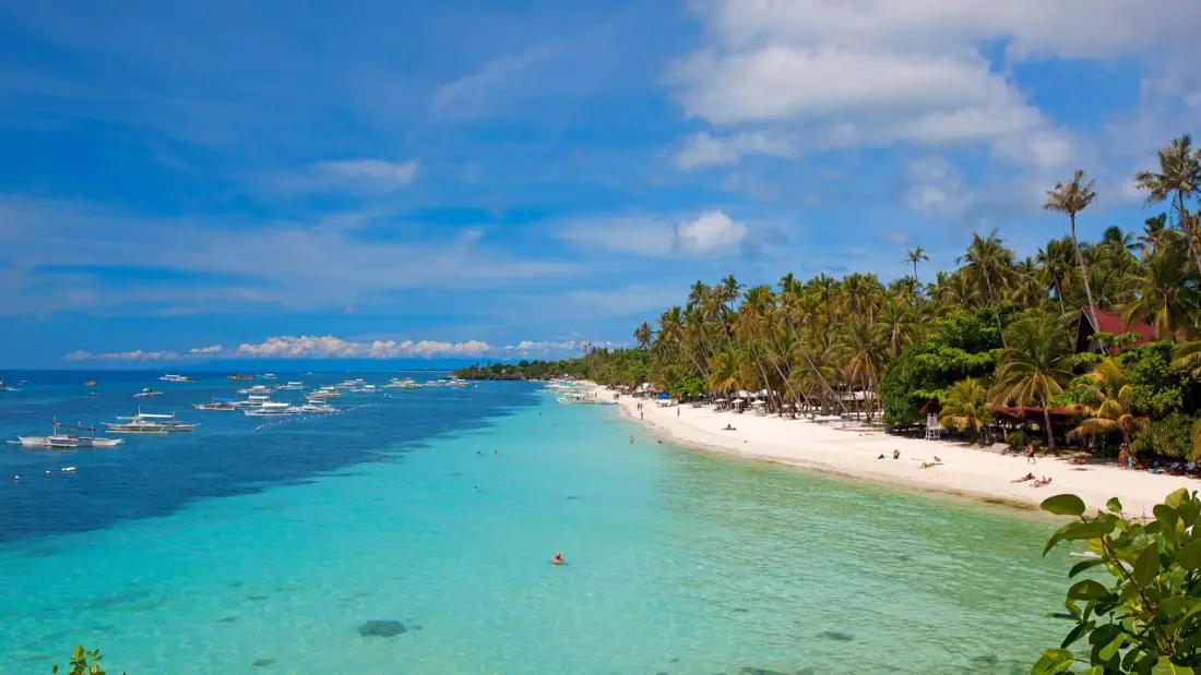 A tropical beach and clear water beneath a bright sky