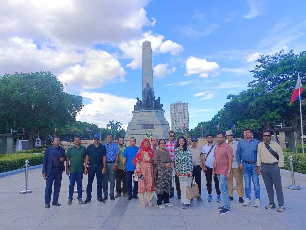 International guests posing in front of the Rizal Monument at Rizal Park in Manila, Philippines.